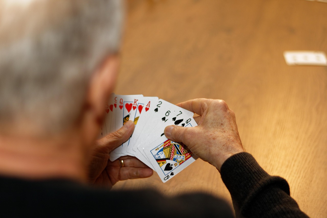 A hand of playing cards being dealt